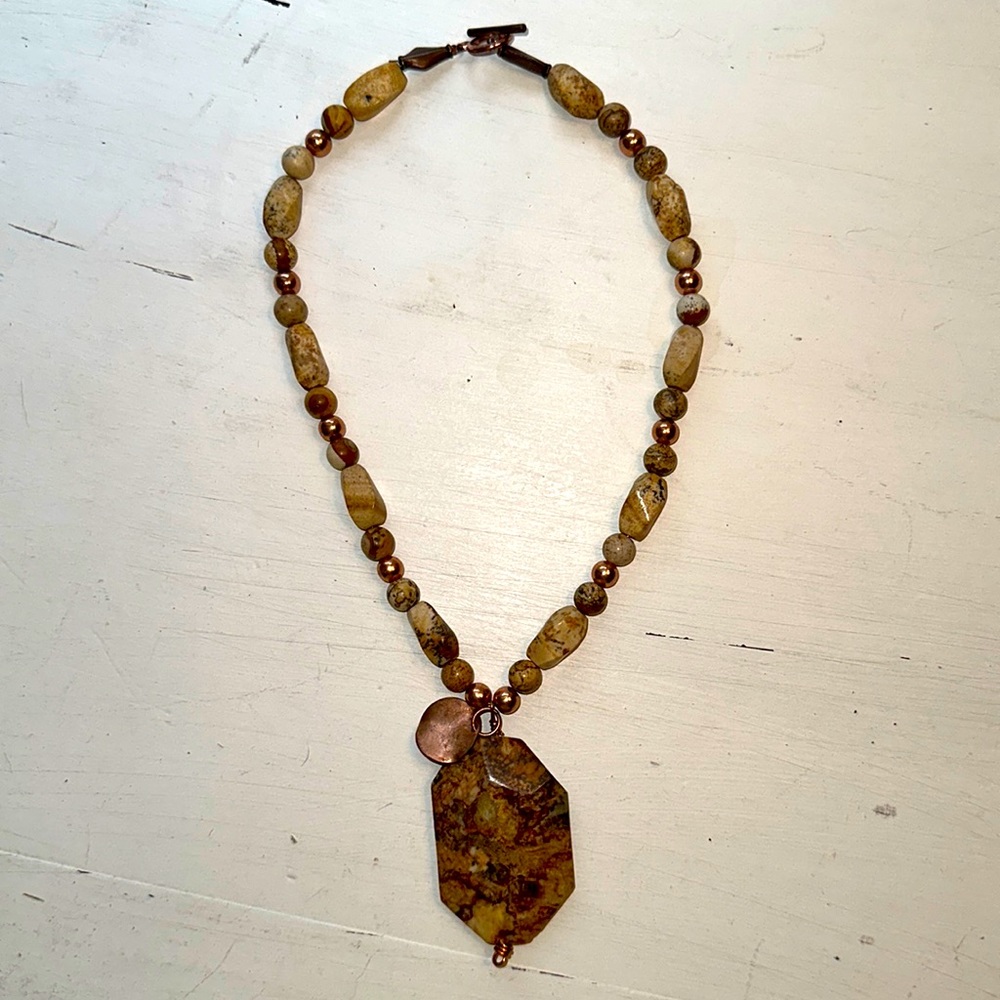 Gently loved handmade beaded and stone necklace. Cream and brown w copper accent